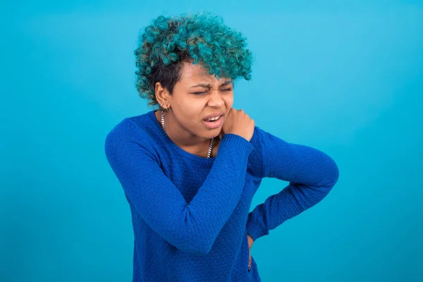 woman with expression of pain in her back isolated on color background