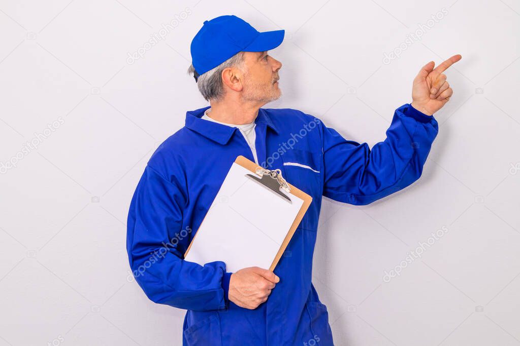 worker isolated on white background pointing blank space