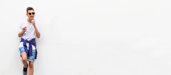 Młody Nastolatek Jedząc Lody Izolowane Białej Ścianie Zewnątrz — Zdjęcie stockowe