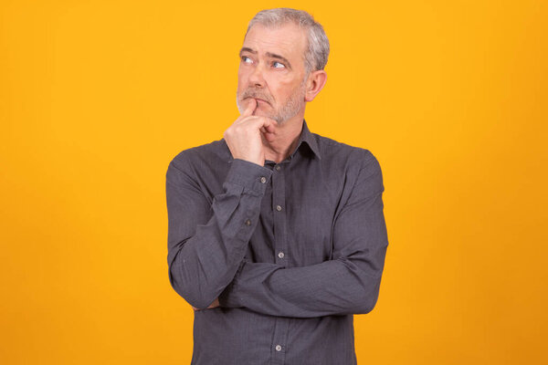 adult man isolated on color background with thoughtful expression