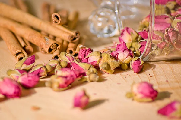 Cinnamon sticks and rose buds in a glass jar