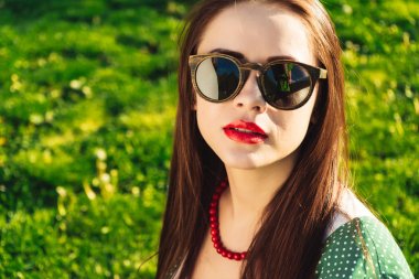 Woman in dark sunglasses,copyspace,grass summer background clipart