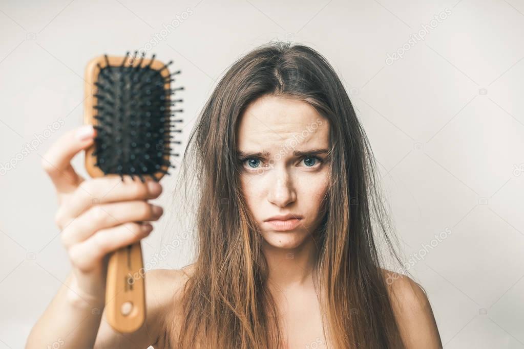 Problems with hair,lost hairs,woman with comb