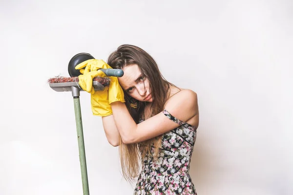 Frustrated young woman cleaning with mop and plunger — Stock Photo, Image