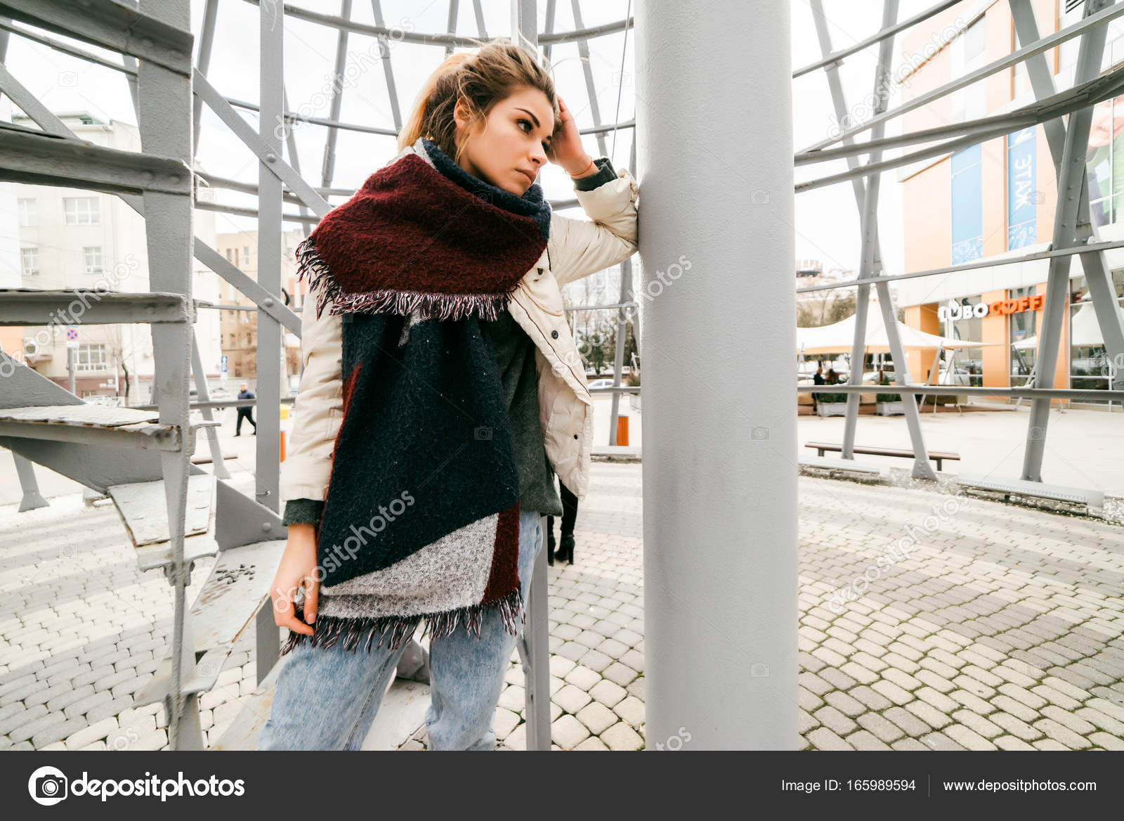 A Beautiful Girl In A Scarf With Blond Hair Pondered Leaned Against A Pillar In The Building Against The Backdrop Of A Staircase Photo By A Beautiful Girl In A Scarf With Blond Hair Pondered Leaned Against A Pillar In The Building Against The Backdrop Of A Staircase Photo By
