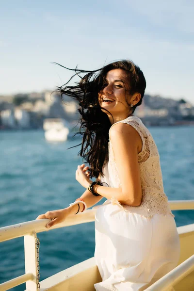 Ung vacker flicka skrattar på ett fartyg, hår är rufsig av vinden — Stockfoto