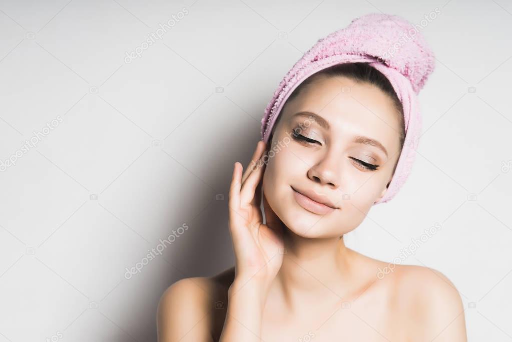 Woman in towel touch her face,healthy skin,isolated