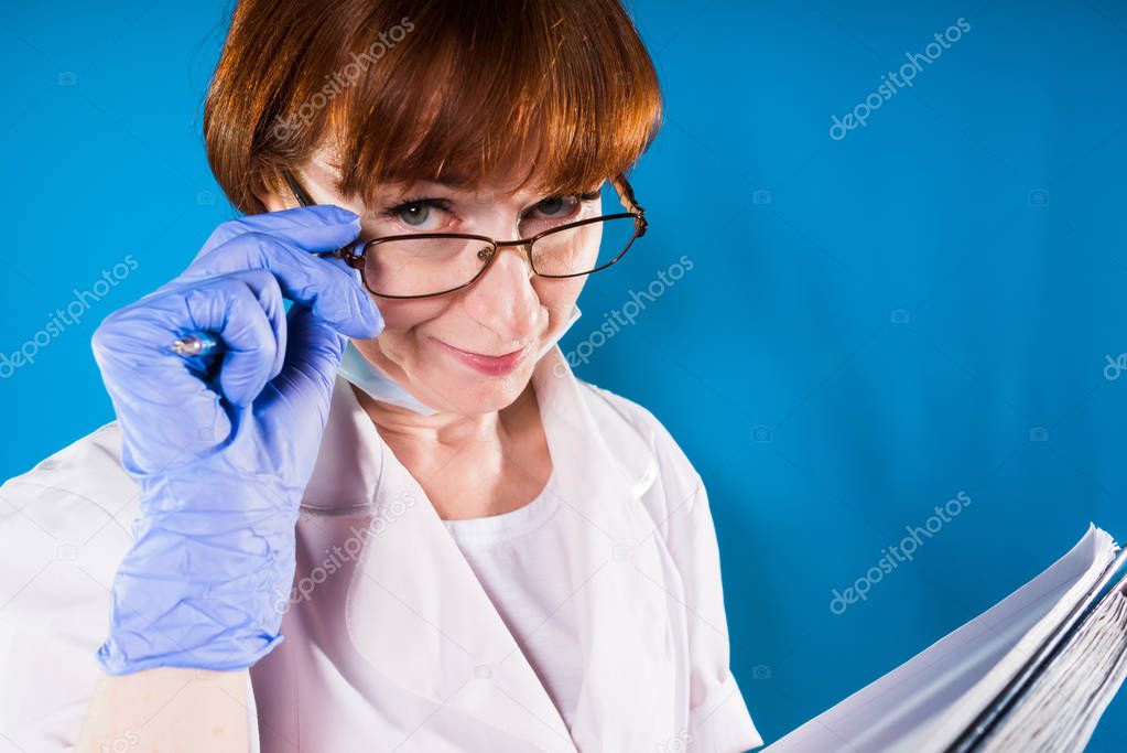 Funny female doctor looks skeptically at camera and takes off glasses, suspects not trusting