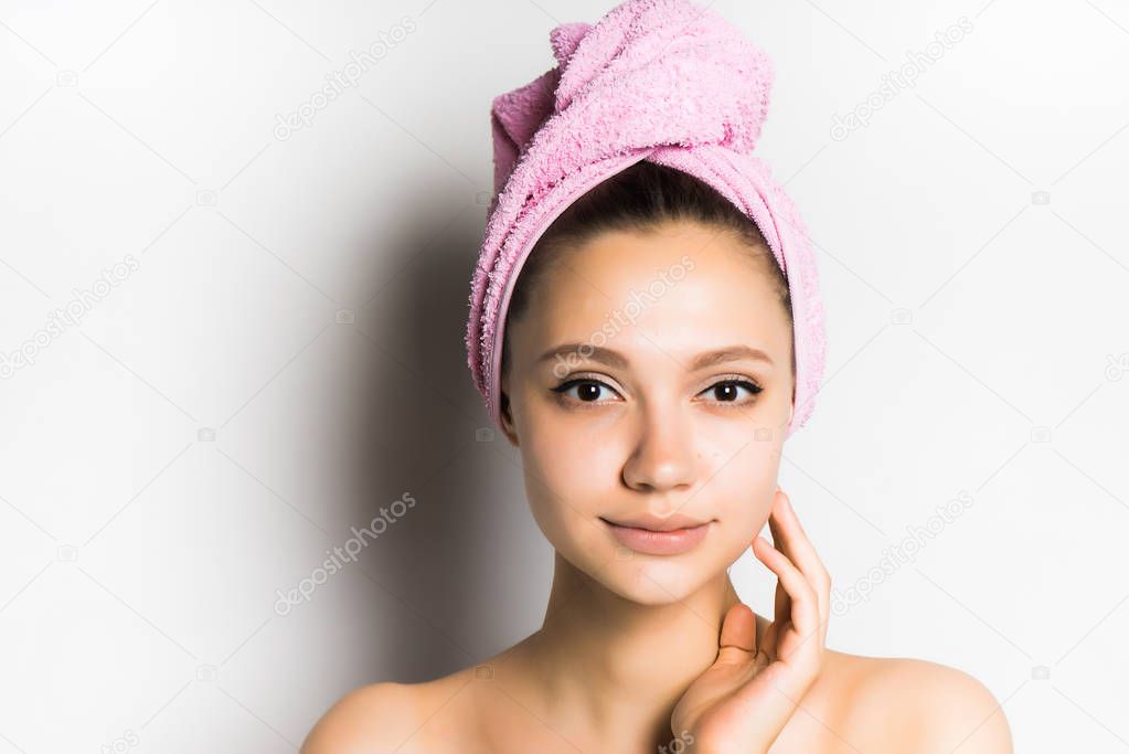 The girl looks after the skin, touches the face. Skin care