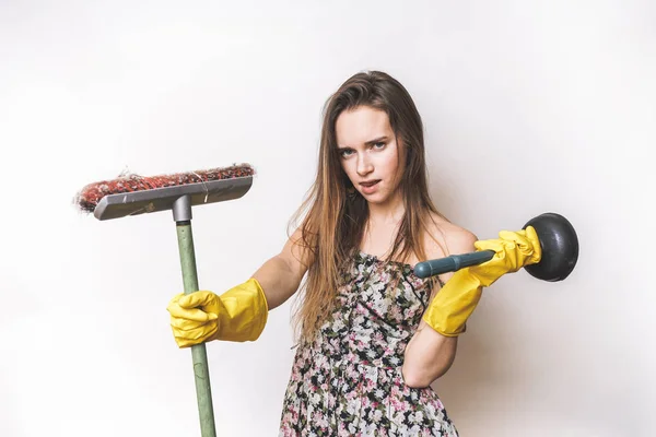 Beautiful girl in a dress with a mop in hands is engaged in cleaning — Stock Photo, Image