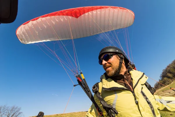 Hombre vestido de turista volando en paracaídas, naturaleza, cielo azul — Foto de Stock