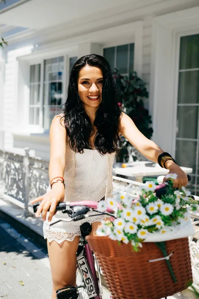 Backet, arka plan, şirketten çiçeklerle bisiklet üzerinde oturan Doğu kız yaz