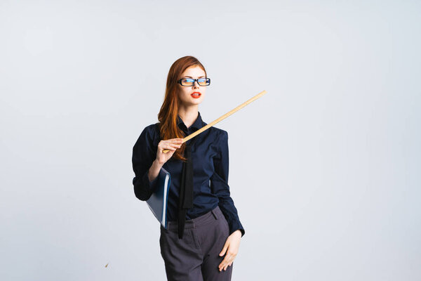 a mysterious red-haired girl with glasses is holding a ruler in her hands and pointing it aside