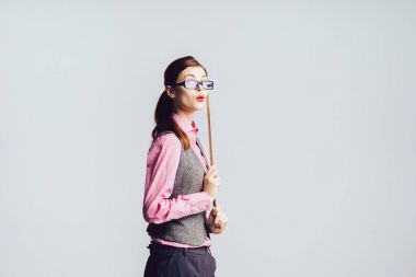 Kız serterat şaşırmış bir ifadeyle bir cetvel onun elinde tutar.