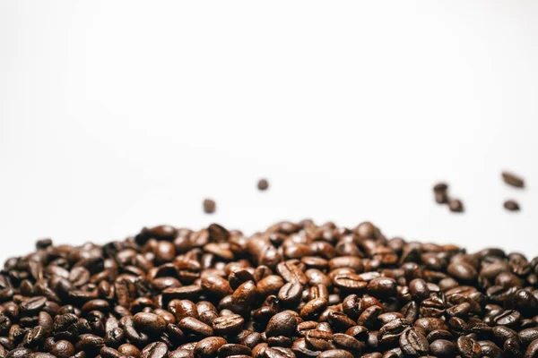 Brown coffee beans close-up on a white background, falling grains — Stock Photo, Image