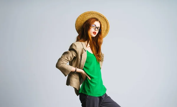 Girl in a hat posing against a white wall background — Stock Photo, Image