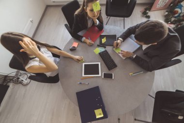 Üstten Görünüm, 2 iş kadın ve bir adam yuvarlak masada oturuyor