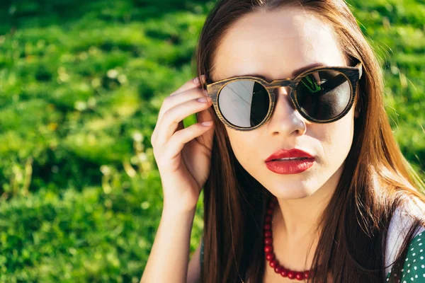 Close up woman face in sunglasses,wooden glasses,white smile — Stock Photo, Image