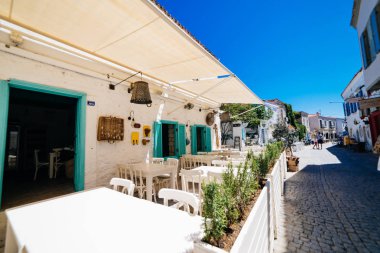 Old city streets in Alacati, Cesme and beautiful blue sky clipart