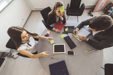 2 hatun ve bir adam ofiste oturan ve bir oyun oynuyor