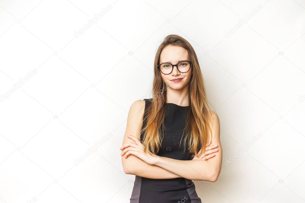 Happy confident young woman in glasses,crossed arms,smiling