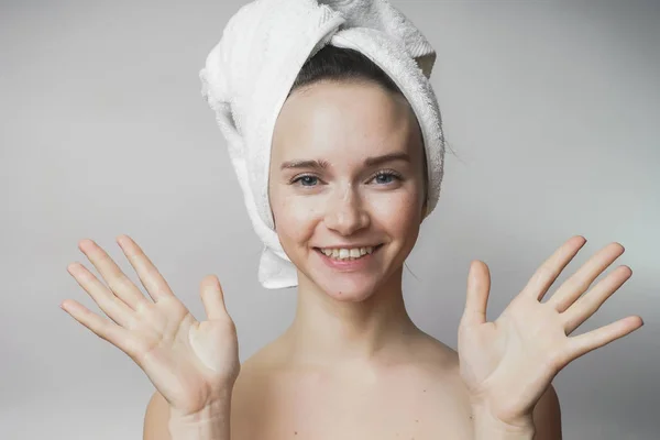 Donna dimostrare pelle pulita, mani, ragazza dopo la doccia, asciugamano sulla testa — Foto Stock