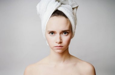 Güzel kadın kameraya bakarak kafasına havlu ile gülümse