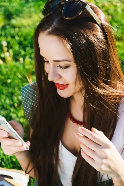 Mujer buscando algo en el móvil, mensajes de texto, adicto, césped verde — Foto de Stock