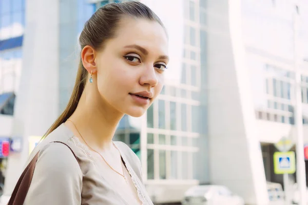 a young girl with plump lips walking around the city