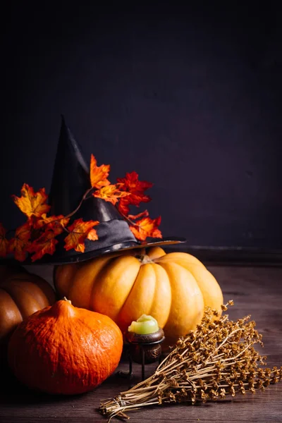 Cadılar Bayramı Balkabağı kafa, sonbahar yaprakları, korkunç şapka siyah bir arka plan, Cadılar Bayramı partisi