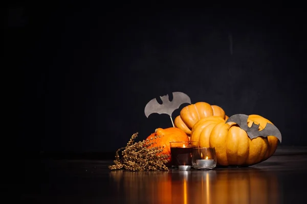 Halloween pumpa på svart bakgrund. Halloween semester konstdesign, firande. Halloweenpumpor med brinnande ljus, fladdermöss — Stockfoto