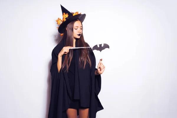 A young gothic girl dressed in a witch for Halloween, conjures — Stock Photo, Image