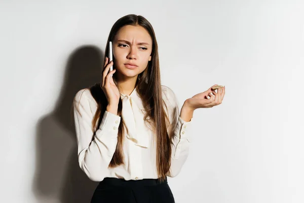 Joven dama de negocios confidente está estudiando criptomoneda, hablando por teléfono, sosteniendo en su mano un bitcoin de oro — Foto de Stock