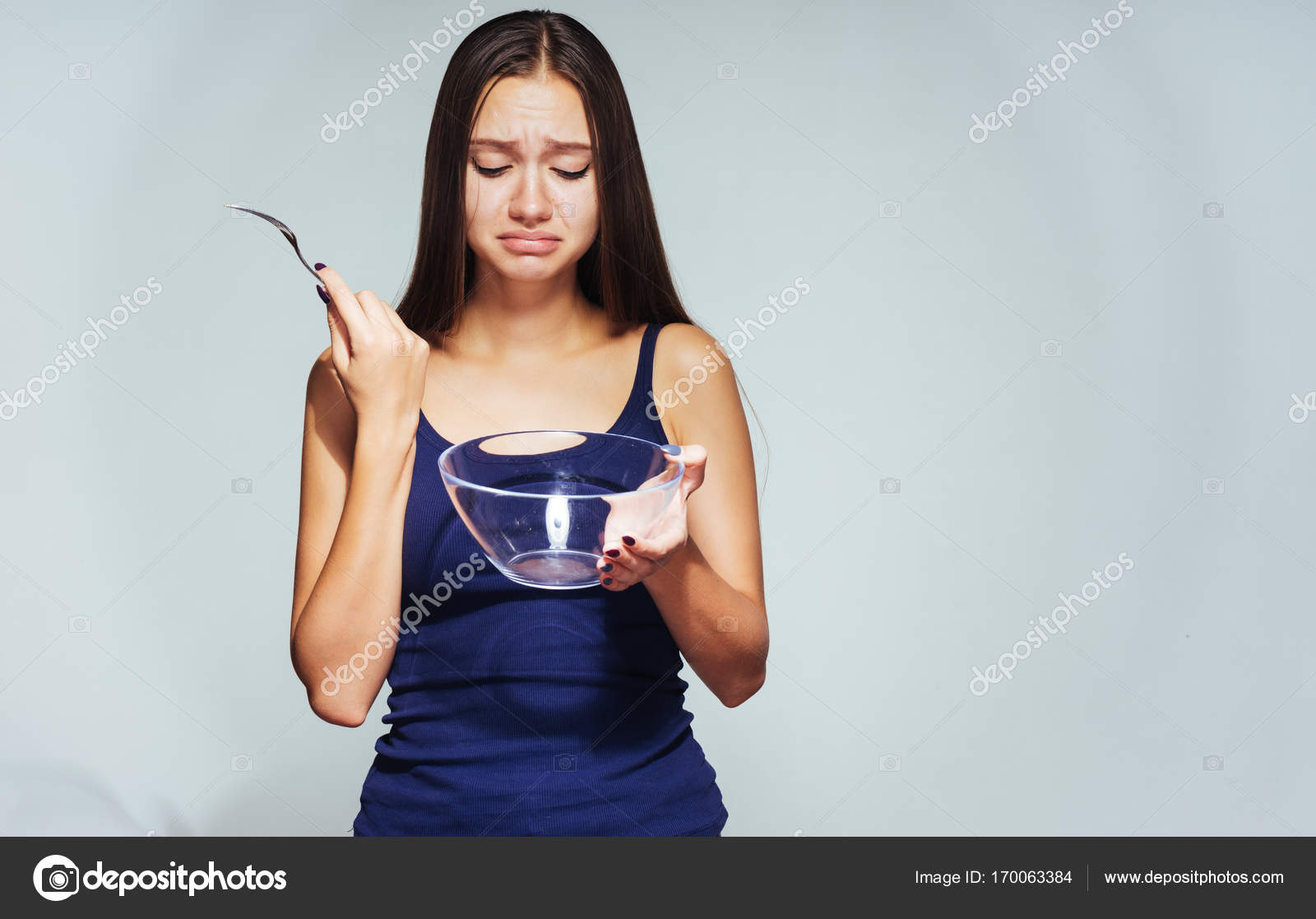 a girl with an empty bowl
