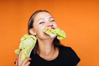 lahana yemek ve onun elinde tutan ve lezzetli bir yemek kameraya bakarak mutlu kız