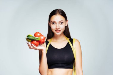 mutlu kız hevesle kameraya bakar ve sebze, sağlıklı yiyecekler yemeye gidiyor