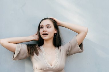 sevimli kız uzun saçları tutar ve uzak görünüyor