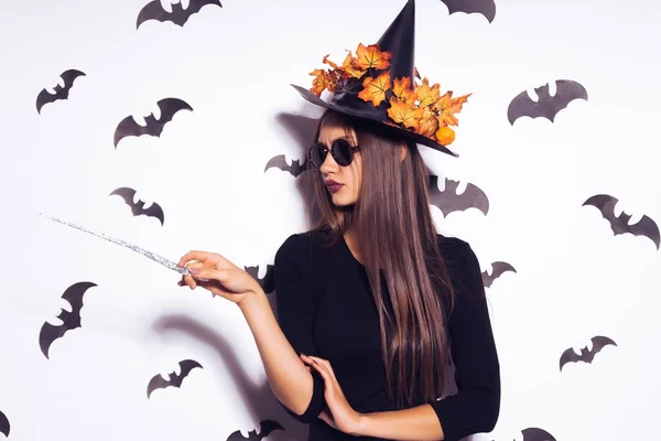 Girl in a witch costume with glasses surrounded by bats — Stock Photo, Image