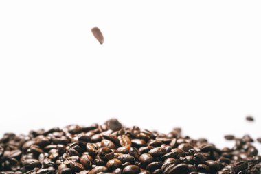 Beyaz bir arka plan üzerinde estetik olarak hoş kokulu kahve kahverengi taneleri yalan