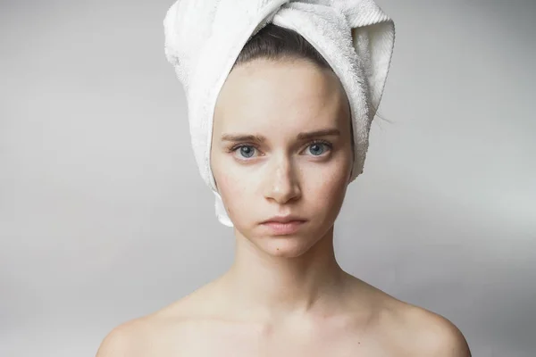 Beautiful woman with towel on the head looking to camera, smile — стоковое фото