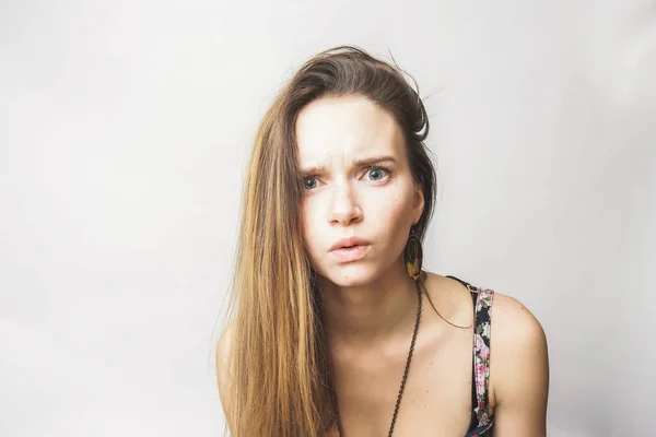 Young scared sad sad girl with blue eyes looking at camera — Stock Photo, Image