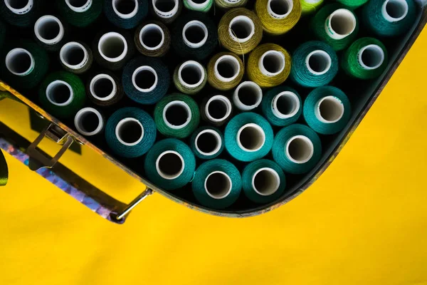 A sárga felület van egy vas doboz tekercsek többszínű szál — Stock Fotó
