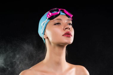 Bir genç atletik kız bir yüzme kap ve gözlük güvenle ileriye bakıyor