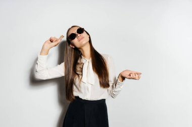 güneş gözlüklü genç başarılı modern kız altın bicoin tutuyor