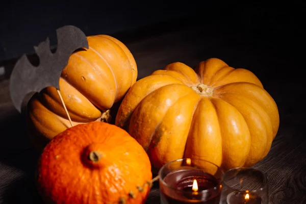 A composition for decorating a house for halloween, orange pumpkins and burning scented candles — Stock Photo, Image