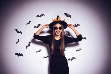 yarasalar tarafından çevrili siyah gözlüklü cadı elbiseli kız