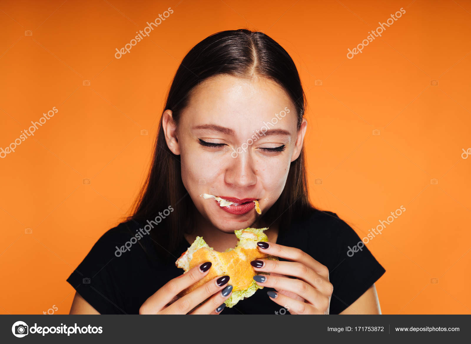 The girl through the laughter eats her burger — Stock Photo © mne_len