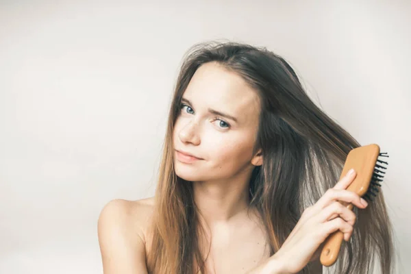 Bonito bela menina pentear seu longo cabelo loiro — Fotografia de Stock