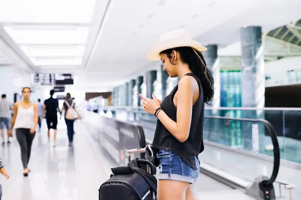 Teenager in airport use smartphone,waiting flight information — Stock Photo, Image