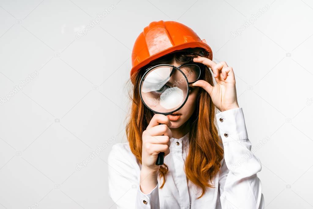 girl in building orange caste looks in huge magnifier, isolated